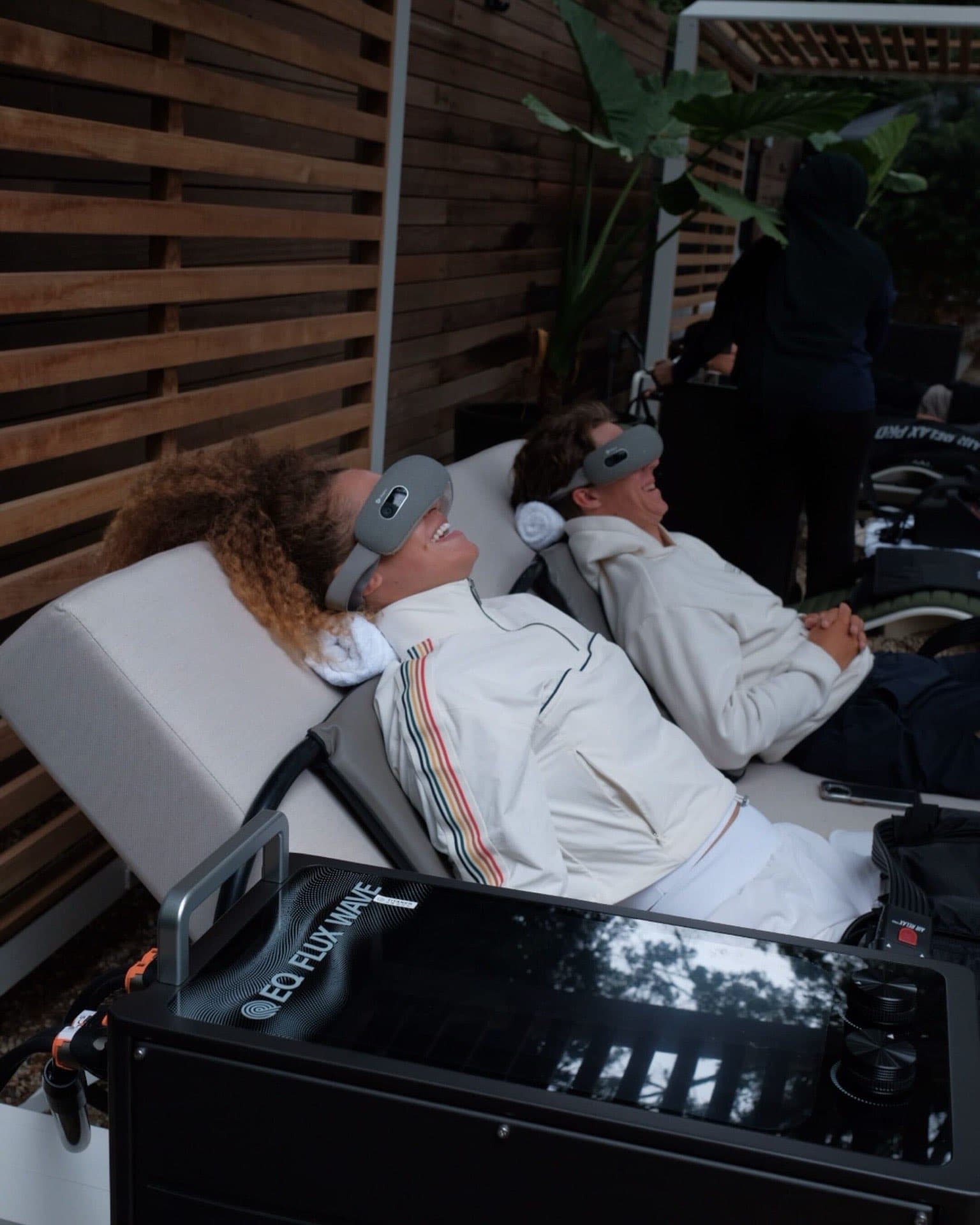 Guests relaxing with EO Flux Wave therapy at a MOCEAN outdoor wellness lounge